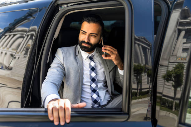 istock Businessman Using Smart Phone in a Limousine 1031760062
