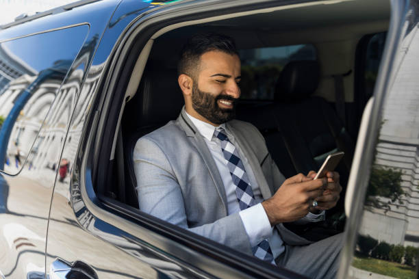 istock Businessman Using Smart Phone in a Limousine 1031760158