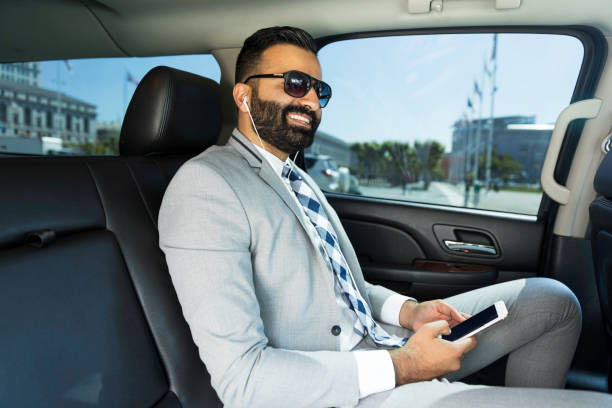 istock Businessman Using Smart Phone in a Limousine 1031760160