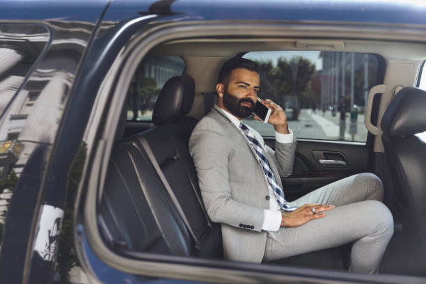 istock Businessman Using Smart Phone in a Limousine 1031761722
