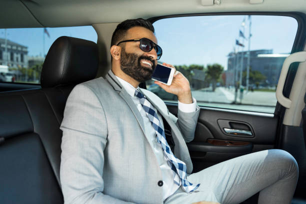 Businessman Using Smart Phone in a Limousine