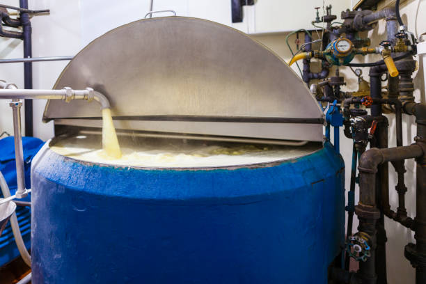 istock Vanilla Ice Cream Mixture Pumped into Large Industrial Ice Cream Making Tank 1031762294