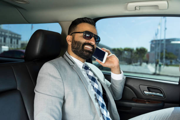 istock Businessman Using Smart Phone in a Limousine 1031762296