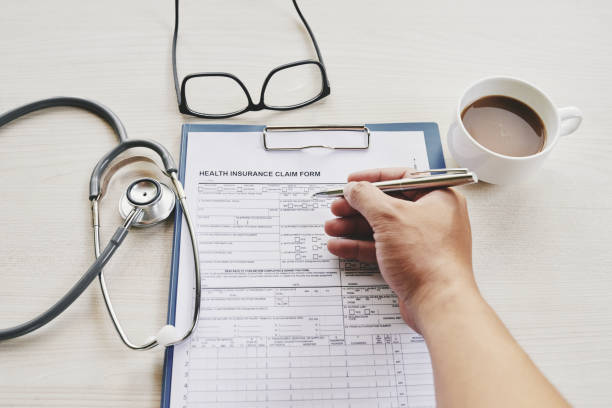 istock Patient filling healthy insurance document 1031795698