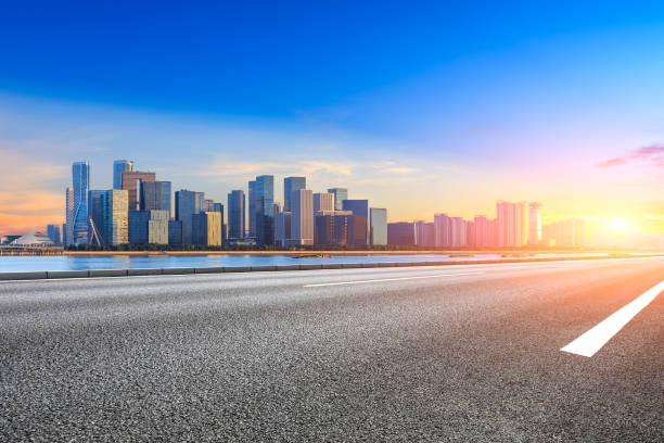 istock Empty asphalt road and modern buildings in Hangzhou at sunrise 1031806224