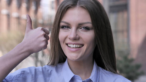 istock Thumbs Up by Young Woman at Work,  Looking at Camera 1031814524