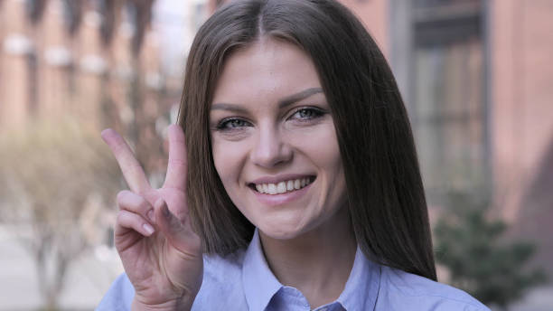 istock Victory Sign by Positive Young Woman 1031814906