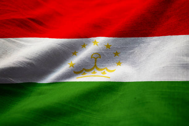 closeup of ruffled tajikistan flag - tajik flag imagens e fotografias de stock
