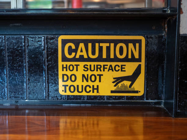 istock Caution hot surface, do not touch sign in front of a grill at a restaurant 1031820504