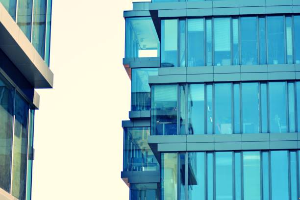 istock Modern office building on a clear sky background. Retro stylized colorful tonal filter effect 1031822208