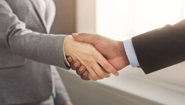 istock Business man and woman shaking hands 1031822224