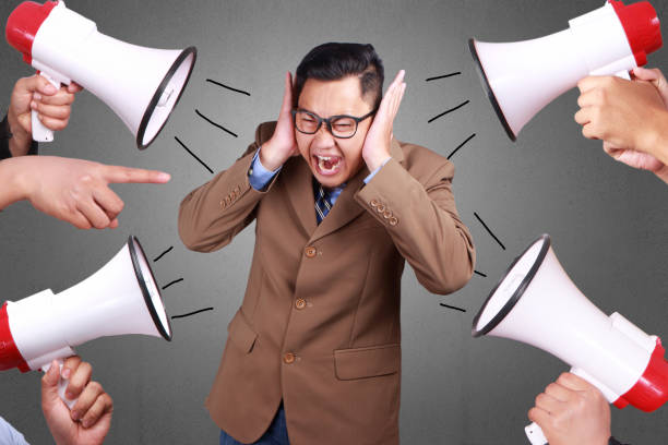 Man Covered his Ear Ignoring Noise Young asian businessman covered his ear ignoring noise. Stressed under pressure concept man closing ears photos stock pictures, royalty-free photos & images