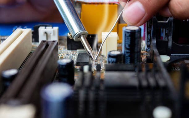 istock The technician repairing the computer mainboard by soldering 1031822728