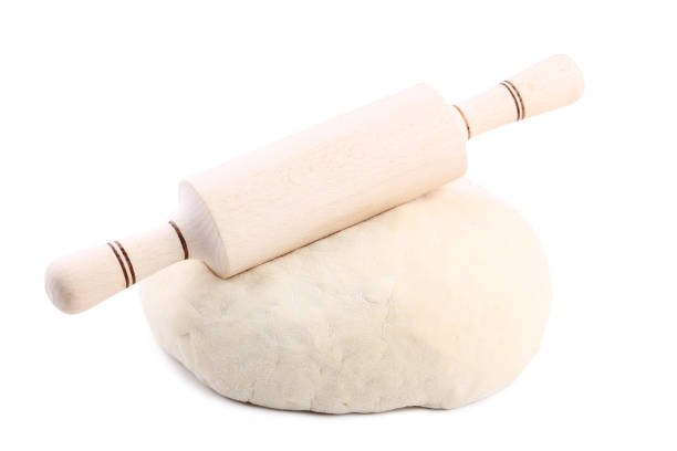 istock Raw dough with rolling pin isolated on white background 1031825388