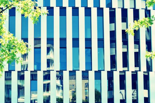 istock Modern office building on a clear sky background. Retro stylized colorful tonal filter effect 1031828630