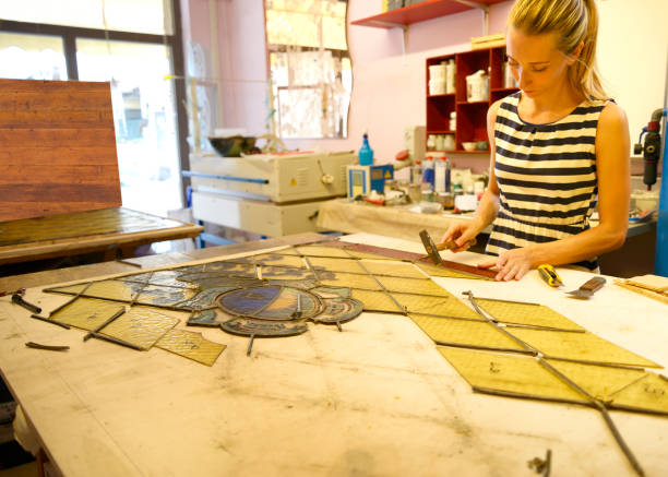 istock Young female artisan restoring old,1890, door glass 1031828704