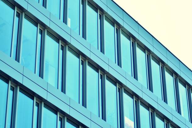 istock Modern office building on a clear sky background. Retro stylized colorful tonal filter effect 1031828766