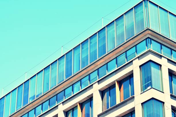 istock Modern office building on a clear sky background. Retro stylized colorful tonal filter effect 1031832624
