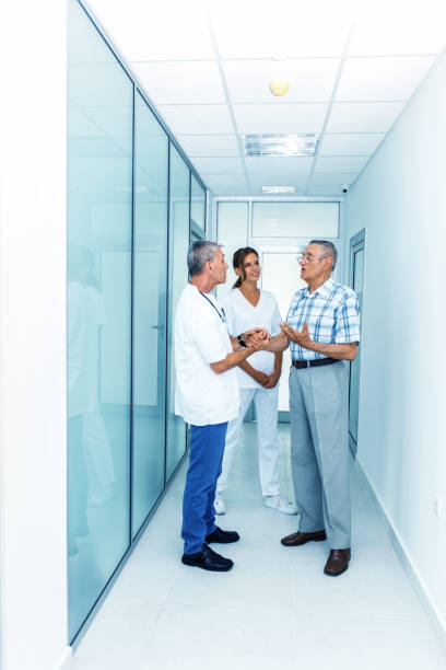 istock Doctor and senior patient talking in corridor 1031832644