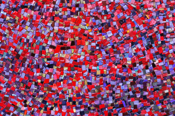 istock Colorful (red, pink, yellow, and purple) stone mosaic tiles on the wall 1031840228