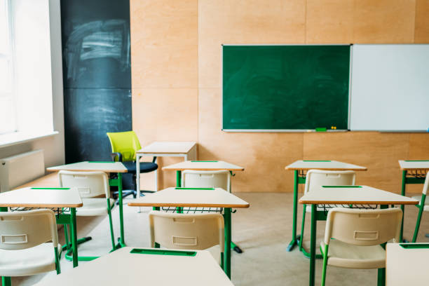 istock interior of empty modern classroom with blank chalkboard at school 1031844758