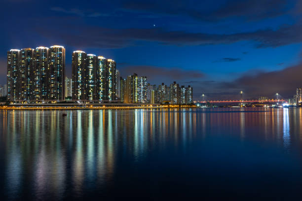 istock Skyscrapers, reflections and illuminated suspension bridge 1031848490