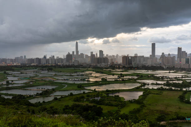 A wide angle shot of the border of Shenzhen and Hong Kong as heavy rain begins to fall on Shenzhen.