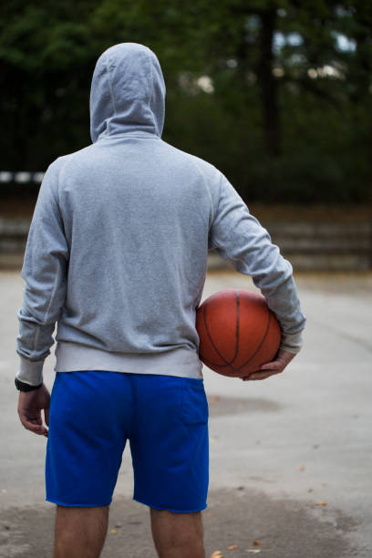 istock Streetball player shoots basket 1031852742