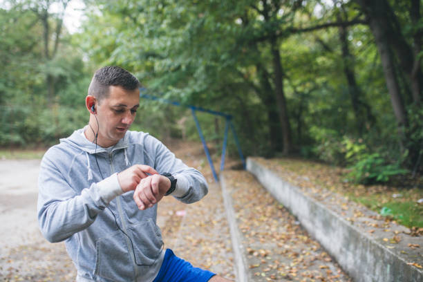 istock Athlete runner adjusting his GPS watch before a run. Close up. 1031853040
