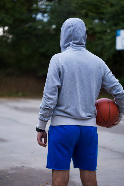 istock Streetball player shoots basket 1031853368