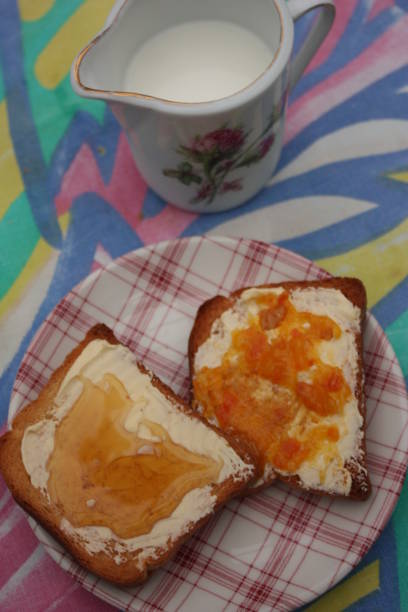 istock Buttered rusks with honey, jam for breakfast  Milk pitcher 1031856878