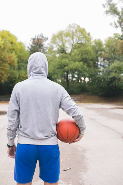 istock Streetball player shoots basket 1031857056