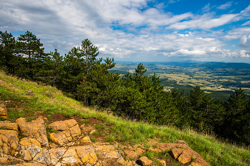 Landscape view from Black peak on Divcibare mountain in Serbia. Landscape with rocks and conifer trees and mountains in the background