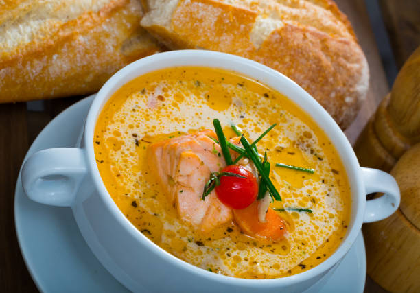 istock Delicious soup with salmon, served  in bowl with fresh bread at table 1031863308