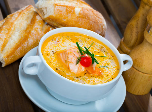 istock Delicious soup with salmon, served  in bowl with fresh bread at table 1031863318