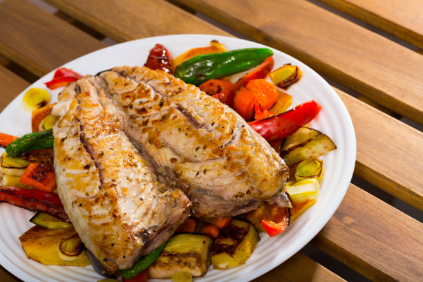 Grilled assorted vegetables served with baked mackerel - traditional Bulgarian Plakiya