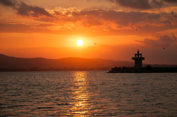 istock Lighthouse against a beautiful evening sunset on the sea. 1031863484
