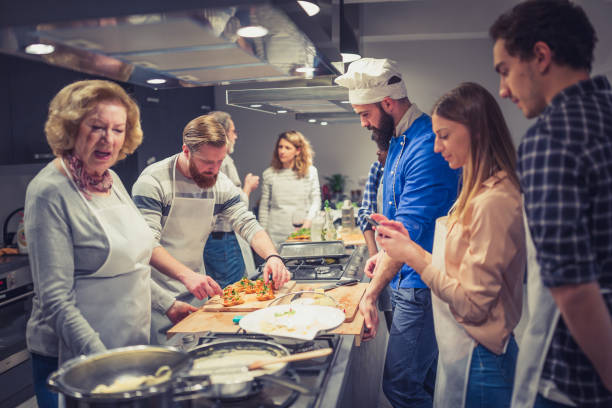 istock Chef is supervising attendees of cooking class while they are making meals 1031866818