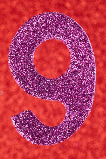 istock Number nine purple color over a red background. Anniversary. 1031867462