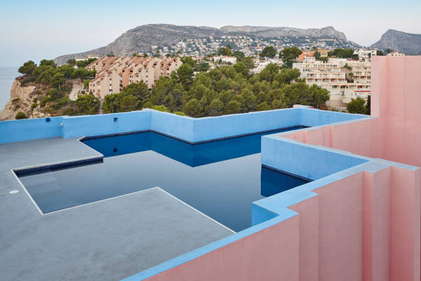 Geometric building swimming pool. Red wall, La manzanera. Spain