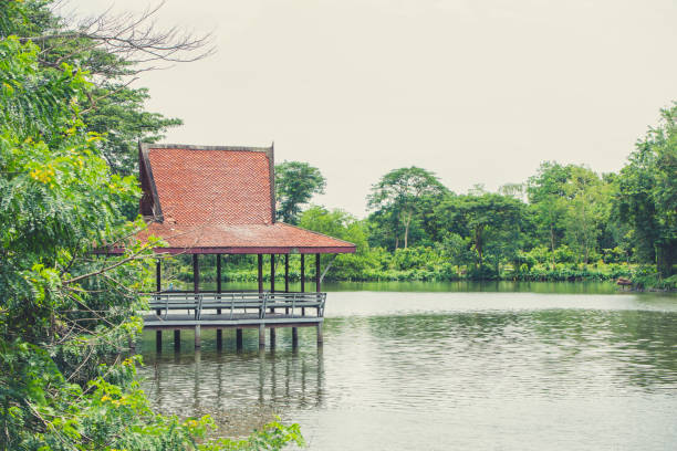 istock Thai traditional small pavilion at riverside lake nature landscape 1031873700