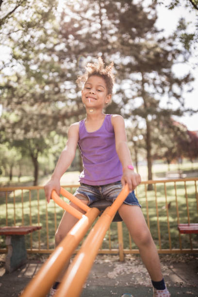 istock Cute little, mixed race girl, outdoors in a playground 1031874024
