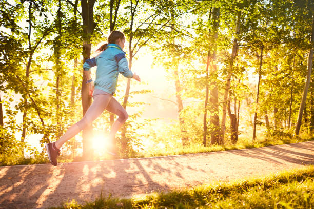 istock Young woman running during sunny morning 1031876824