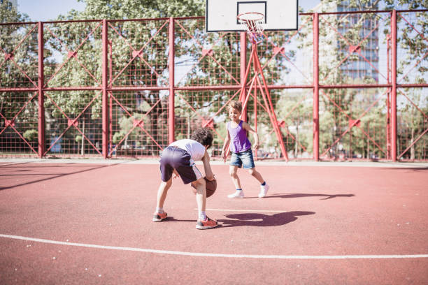 istock Cute, mixed-race siblings playing basketball 1031877452