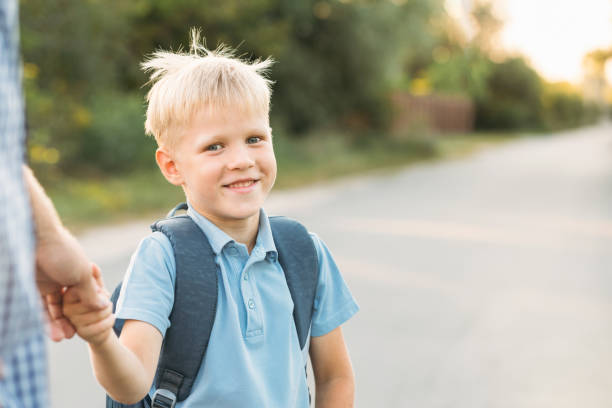 istock Little son holding father's hand and smiling. 1031877650