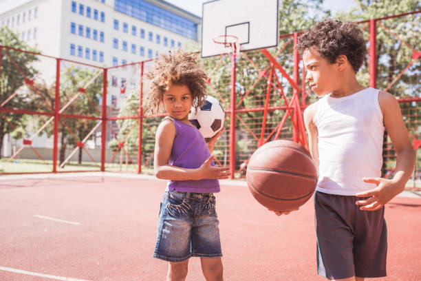 istock Cute, mixed-race siblings playing basketball 1031877698