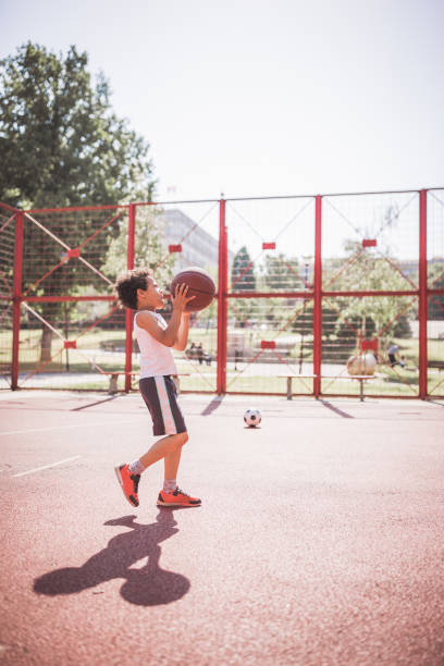 istock Cute little-mixed race boy, playing basketball 1031877700