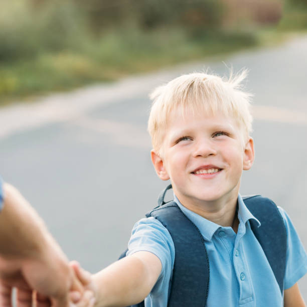 istock Little son holding father's hand and smiling. 1031877770