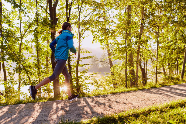 istock Fit woman running in park during sunrise 1031877842