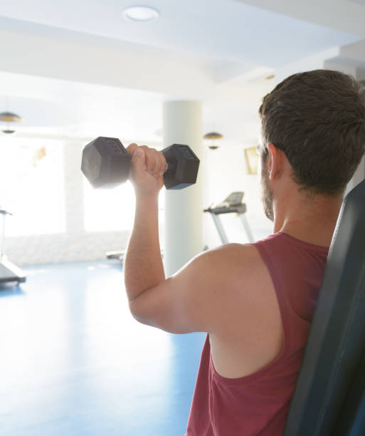 istock Man workout with dumbbells at the gym 1031880018